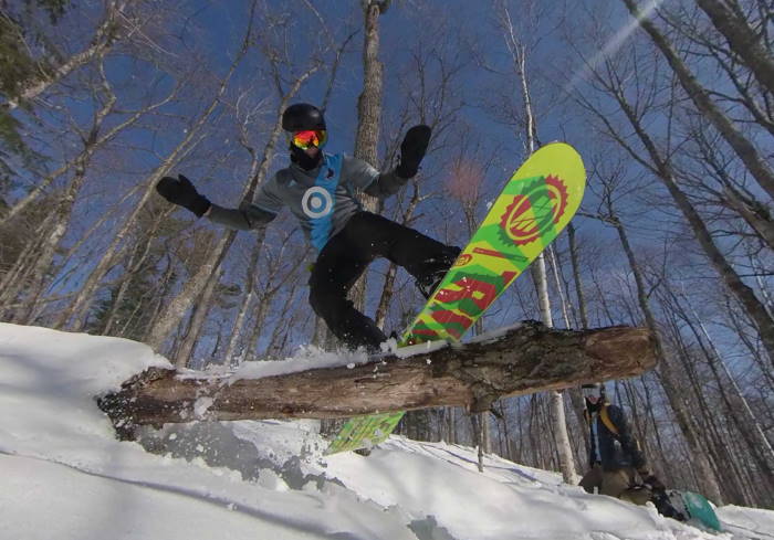 Ben board slides a tree branch.